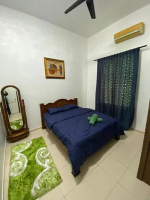 a bedroom with a bed and a mirror in it at Laman Moon Homestay, Melaka in Gua Sai