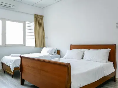 a bedroom with two beds and a window at Lodge 22, 5 min walk to Adventist & Pulau Tikus Market in George Town