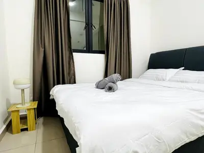 a bedroom with a bed with a stuffed animal on it at SunshineResidence 5pax Near Georgetown in Ayer Itam