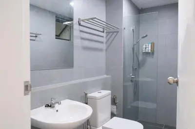 a bathroom with a toilet and a sink and a shower at SunshineResidence 5pax Near Georgetown in Ayer Itam