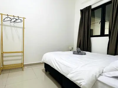 a bedroom with a white bed and a window at SunshineResidence 5pax Near Georgetown in Ayer Itam