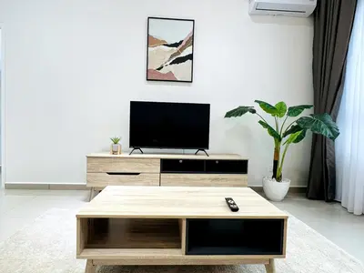 a living room with a tv and a coffee table at SunshineResidence 5pax Near Georgetown in Ayer Itam