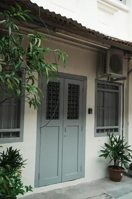 a house with a blue door and windows at Hutton Haven by MyStay in George Town