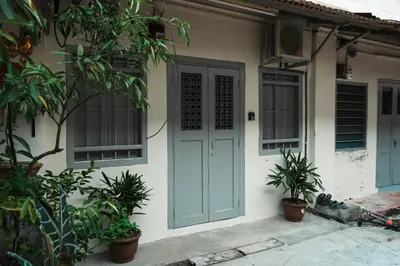 a house with a blue door and some plants at Hutton Haven by MyStay in George Town