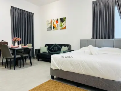 a bedroom with a large bed and a dining room at Venus Suite in Setia Alam 2 in Gua Sai
