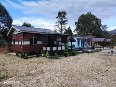a small house with a large yard at Homestay Teratak D'Desa in Gua Sai