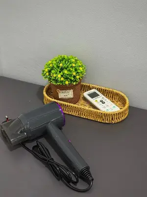 a hair dryer sitting next to a basket with a plant at Modern & Cozy Home Stay in Kampar