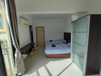 a bedroom with a bed with a laptop on it at 3B2BR Marina Height Seaview room Rose in Lumut