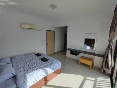 a bedroom with a bed and a desk and a television at 3B2BR Marina Height Seaview room Rose in Lumut