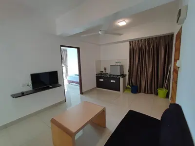 a living room with a couch and a table in it at 3B2BR Marina Height Seaview room Rose in Lumut