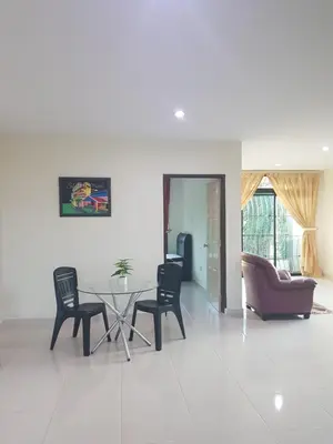 a living room with a table and chairs at Kulim LakeView Homestay for Msliims Only in Kulim
