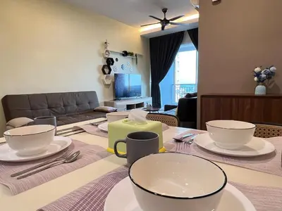 a living room with a table with dishes on it at G Home 3 - Ipoh City Centre Majestic 2R2B in Ipoh