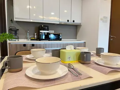 a kitchen with a table with cups and dishes on it at G Home 3 - Ipoh City Centre Majestic 2R2B in Ipoh