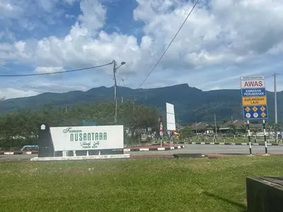 a sign for a tissott store on the side of a road at Villa Umar Home Stay in Gua Sai