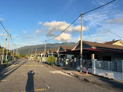 a shadow of a person standing on a street at Villa Umar Home Stay in Gua Sai