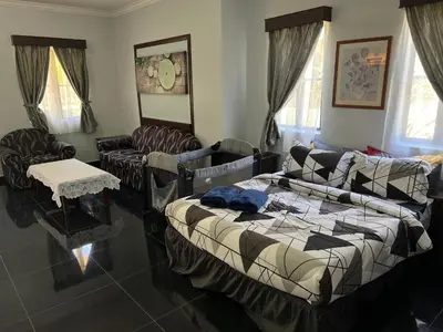 a living room with a bed and a couch at DamaiNest in Lumut