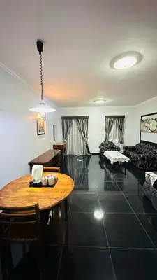 a living room with a table and a couch at DamaiNest in Lumut