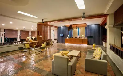 a living room with a couch and chairs and a table at DamaiNest in Lumut