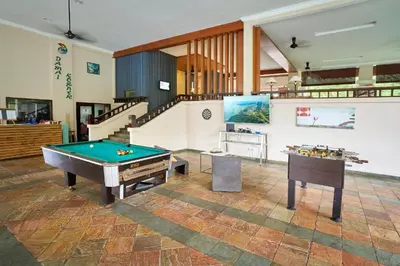 a room with a pool table and a staircase at DamaiNest in Lumut