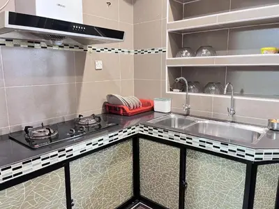 a kitchen with a sink and a stove at Menglembu Hill Home Stay in Ipoh