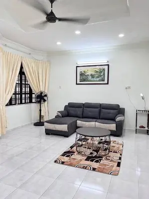 a living room with a couch and a rug at Menglembu Hill Home Stay in Ipoh