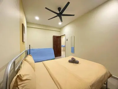 a bedroom with a bed with a ceiling fan at Vintage CoLiving 2Storey Haus in Bukit Mertajam