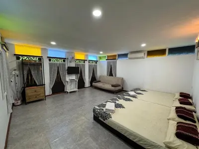 a bedroom with a bed and a couch in it at Rumah Inap Kampung Agong Tempua in Penaga