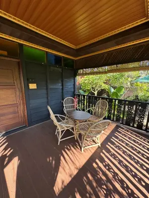 a patio with a table and chairs on a porch at Rumah Inap Kampung Agong Tempua in Penaga