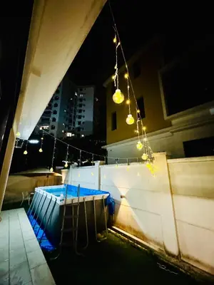 a view of a swimming pool at night at Private Pool Villa Near Batu Ferringhi Beach in Batu Ferringhi