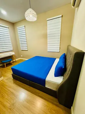 a bedroom with a bed with blue sheets and a couch at Private Pool Villa Near Batu Ferringhi Beach in Batu Ferringhi