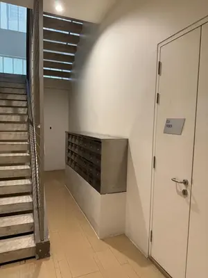 a staircase in a building with a door and a stair case at By The Sea Batu Ferringhi, Penang Beach in Batu Ferringhi