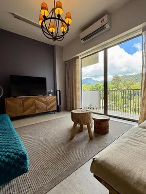 a bedroom with a bed and a large window at By The Sea Batu Ferringhi, Penang Beach in Batu Ferringhi
