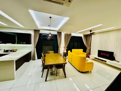 a living room with a dining table and yellow chairs at Batu Ferringhi Home Near Beach in Penang with private pool in Batu Ferringhi