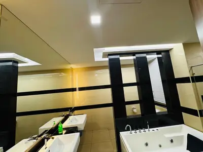 a bathroom with two sinks and a mirror at Batu Ferringhi Home Near Beach in Penang with private pool in Batu Ferringhi
