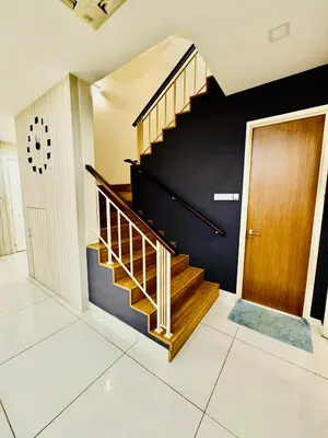 a staircase in a house with a wooden door at Batu Ferringhi Home Near Beach in Penang with private pool in Batu Ferringhi