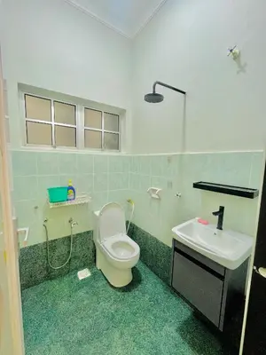 a bathroom with a toilet and a sink at Homestay Deedora 87 in Seri Manjung