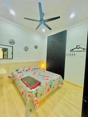 a bedroom with a bed and a ceiling fan at Homestay Deedora 87 in Seri Manjung