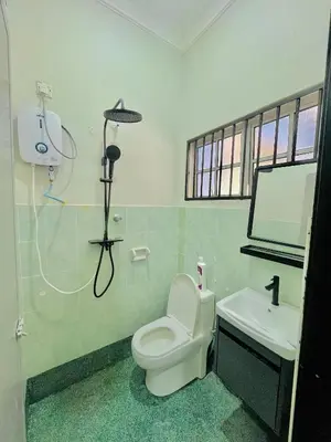 a bathroom with a white toilet and a sink at Homestay Deedora 87 in Seri Manjung