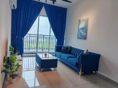 a living room with a blue couch and a large window at Galaxy Luxury Homestay in Bukit Mertajam