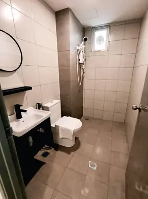 a bathroom with a toilet and a sink at Galaxy Luxury Homestay in Bukit Mertajam