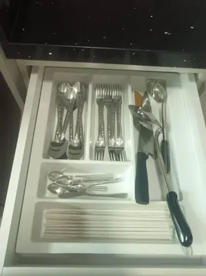 a drawer full of utensils in a white drawer at Galaxy Luxury Homestay in Bukit Mertajam