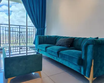a blue couch in a living room with a window at Galaxy Luxury Homestay in Bukit Mertajam