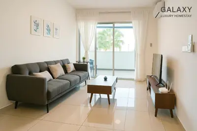 a living room with a couch and a tv at Galaxy Luxury Homestay in Bukit Mertajam