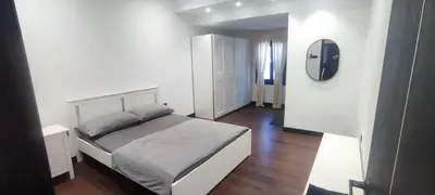 a bedroom with a white bed and a mirror at Akasea Sojourn in Gua Sai