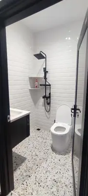 a white bathroom with a toilet and a sink at Akasea Sojourn in Gua Sai