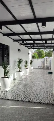 a group of plants in white pots on a patio at Akasea Sojourn in Gua Sai