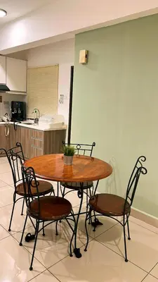 a wooden table and chairs in a kitchen at GA Homes Homestay - Majestic Ipoh Condo in Ipoh
