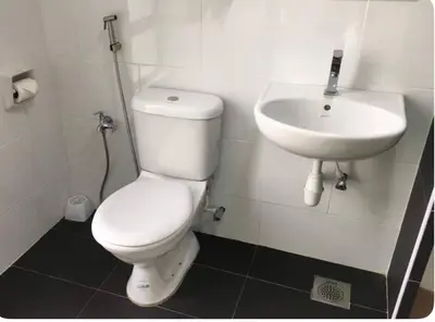 a bathroom with a white toilet and a sink at GA Homes Homestay - Majestic Ipoh Condo in Ipoh