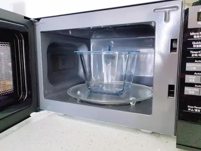 a glass bowl inside of a microwave oven at Urban Suites Jelutong Georgetown 2BR Leisure City Night View in Jelutong