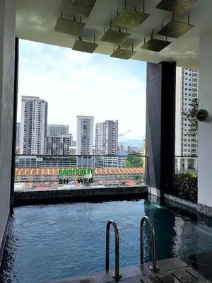 a swimming pool in a building with a view of a city at Urban Suites Jelutong Georgetown 2BR Leisure City Night View in Jelutong